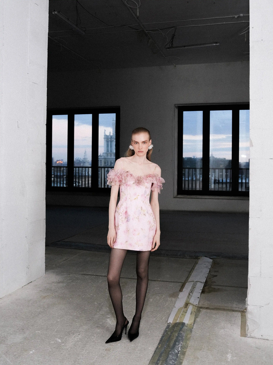 May mini, mini dress in pink organza with a floral print, ruffles, and a rose detail