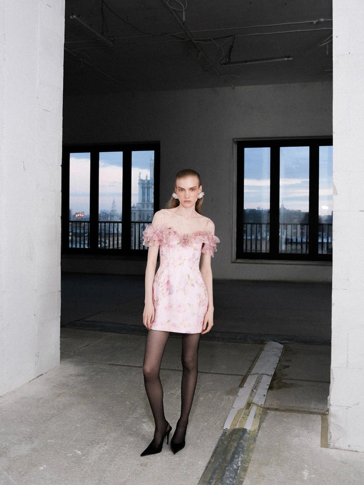 May mini, mini dress in pink organza with a floral print, ruffles, and a rose detail