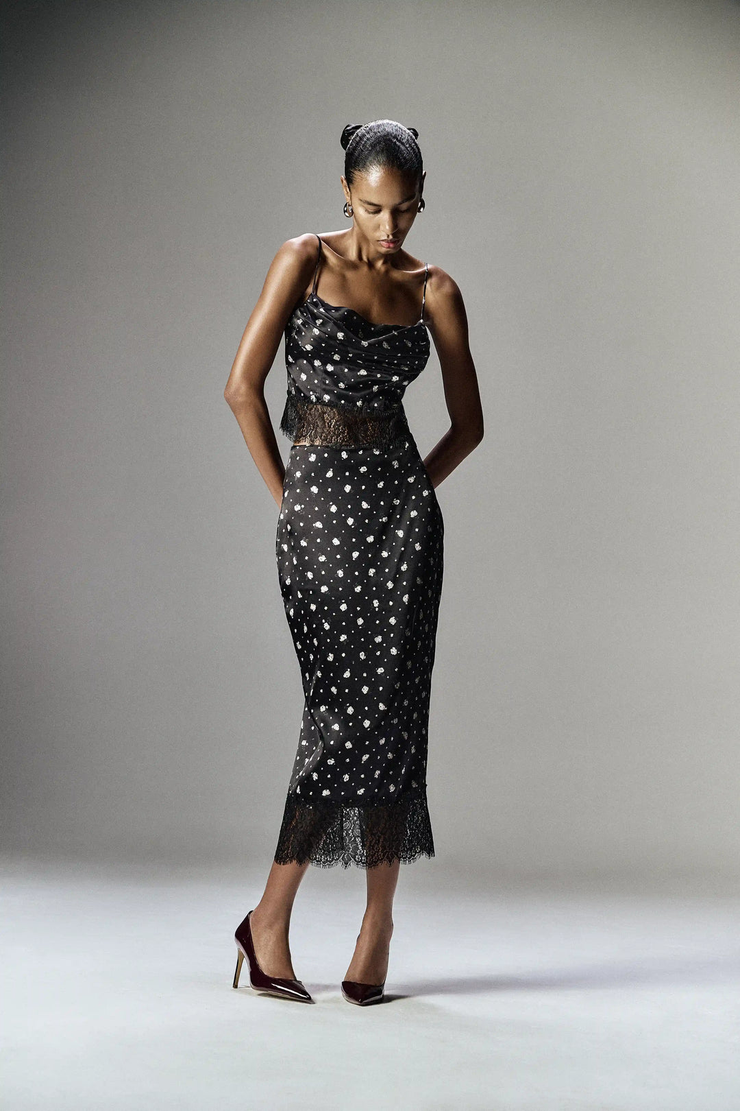 Cassie, top made of black satin with small floral print