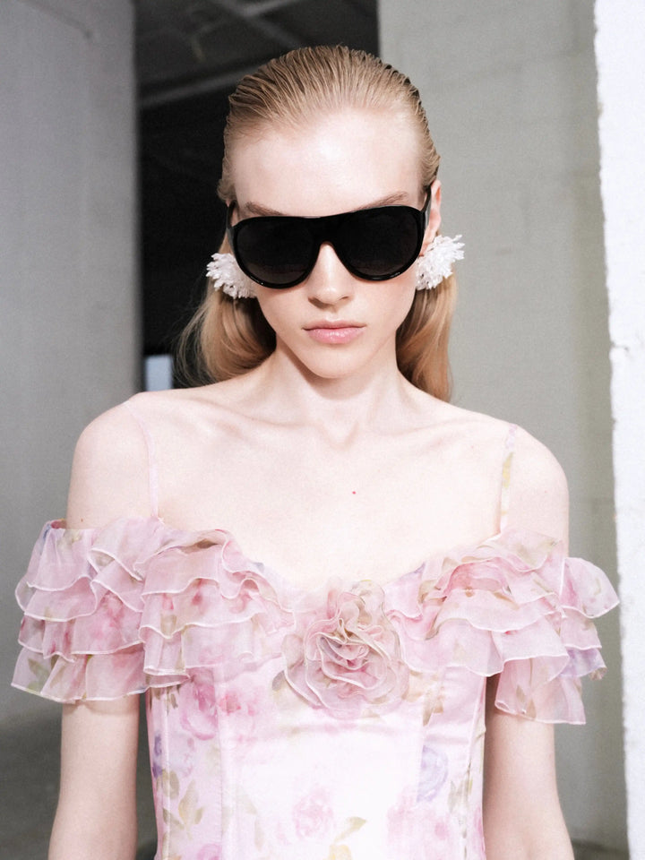 May mini, mini dress in pink organza with a floral print, ruffles, and a rose detail