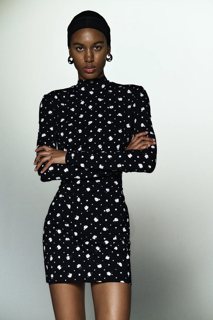 Muna mini, mini dress with long sleeves made of black biflex with small floral print