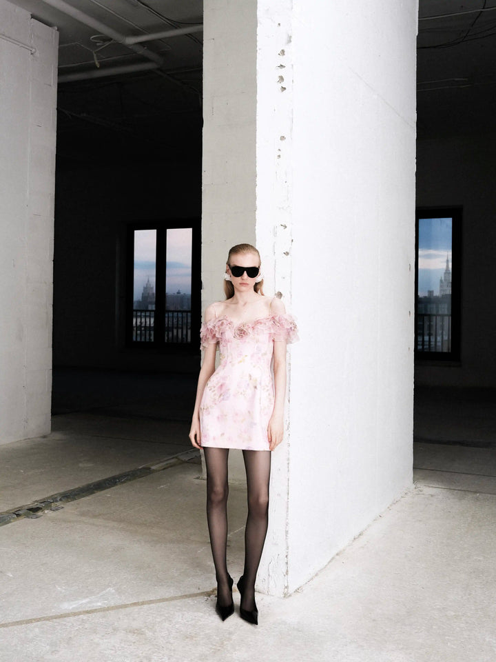 May mini, mini dress in pink organza with a floral print, ruffles, and a rose detail