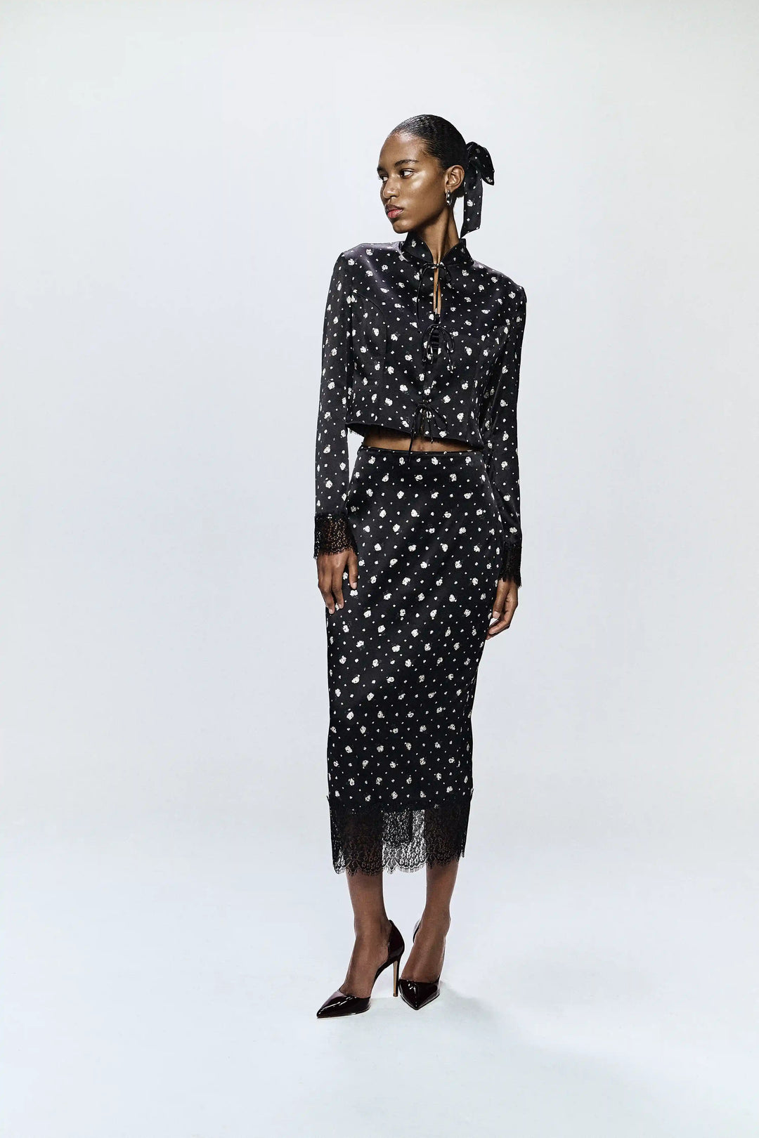 Chona, jacket made of black satin with small floral print