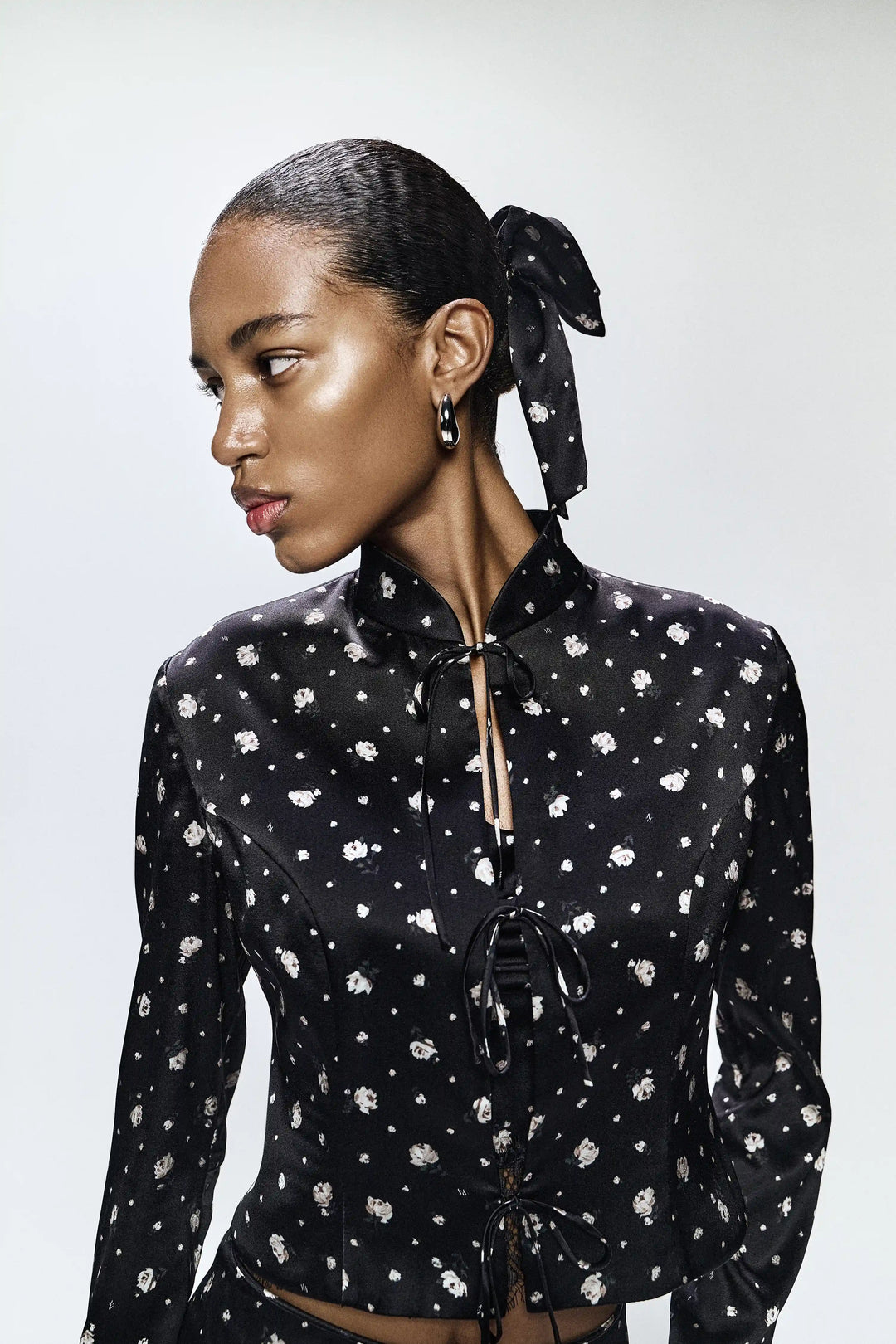 Chona, jacket made of black satin with small floral print