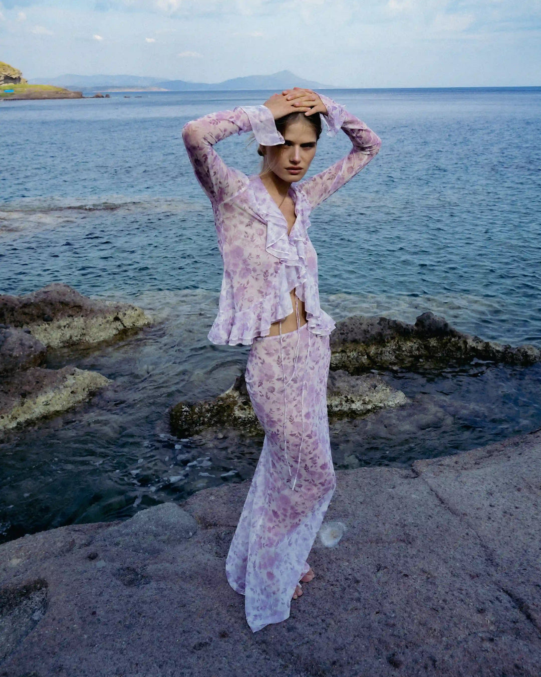 Roxanna mesh, beach blouse with sleeves and ruffles made of ivory mesh with medium lilac flowers