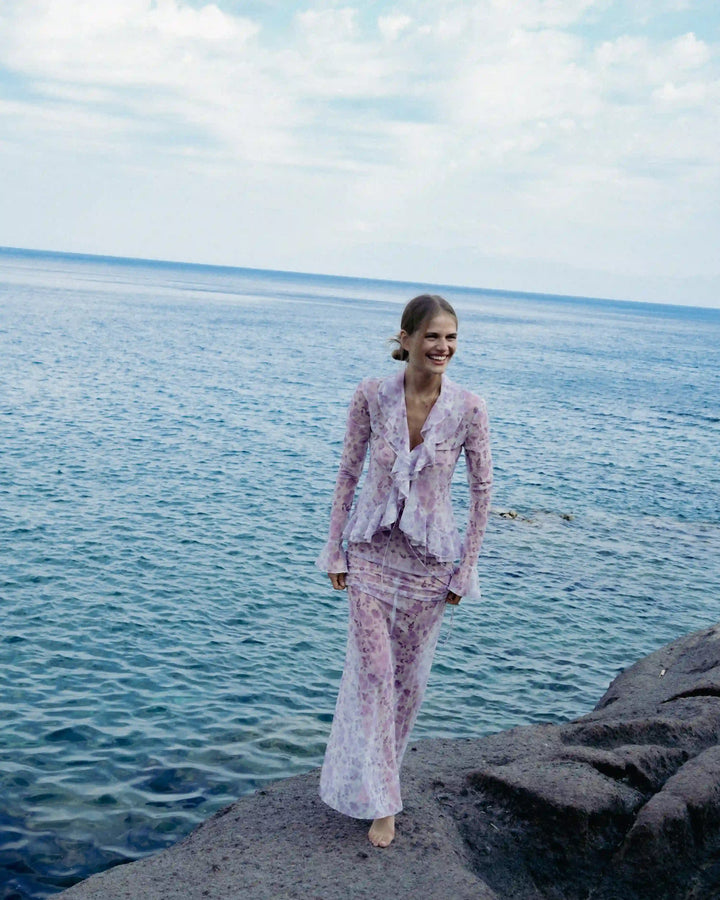 Roxanna mesh, beach blouse with sleeves and ruffles made of ivory mesh with medium lilac flowers