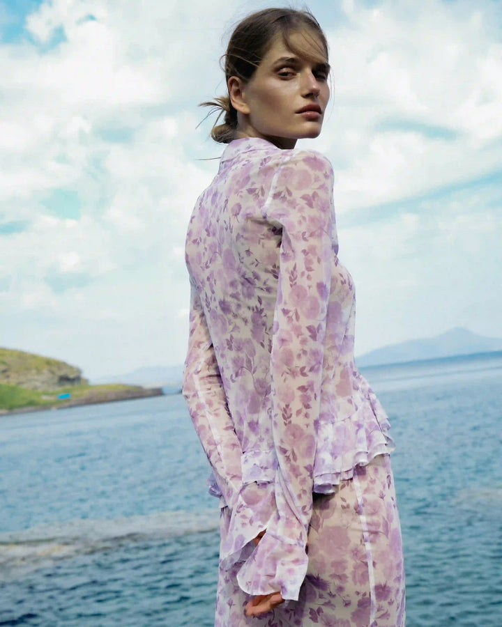Roxanna mesh, beach blouse with sleeves and ruffles made of ivory mesh with medium lilac flowers
